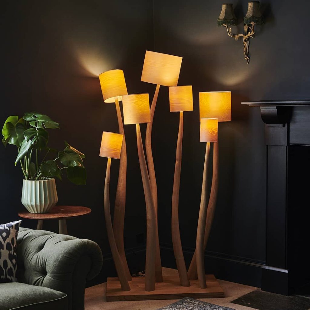 Group of hand carved wooden lamps in a dark room