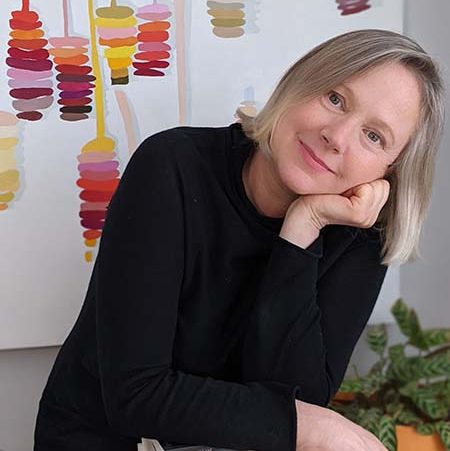 Jane Langley in her studio in front of a painting. 